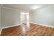 Spacious living area featuring sleek hardwood floors, neutral paint, and abundant natural light at 884 Custer Se Ave, Atlanta, GA 30316