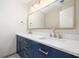 Modern bathroom with blue vanity, quartz countertops, and gold fixtures at 18 Ivy Ne Rdg, Atlanta, GA 30342