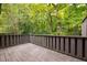 Private deck overlooking wooded area with dark brown railing at 18 Ivy Ne Rdg, Atlanta, GA 30342