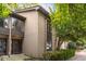 Tan two-story townhome with dark brown front door and landscaping at 18 Ivy Ne Rdg, Atlanta, GA 30342