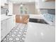 Modern white kitchen with hexagon floor tile, quartz countertops and gold accents at 18 Ivy Ne Rdg, Atlanta, GA 30342