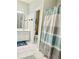 Bright bathroom boasts a shower/tub combo, white vanity, and updated fixtures at 651 Hexham Ct, Suwanee, GA 30024