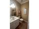 Powder room features a white vanity, toilet, and decorative artwork at 651 Hexham Ct, Suwanee, GA 30024