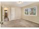 Well-lit bedroom with neutral carpeting and dual windows at 5531 Wild Cherry Sw Dr, Mableton, GA 30126