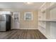 Kitchen dining area with hardwood floors and built-in shelving at 5531 Wild Cherry Sw Dr, Mableton, GA 30126