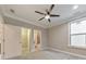 Bright bedroom featuring a ceiling fan and an ensuite bathroom at 630 Eagles Lndg, Woodstock, GA 30188