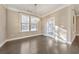 Bright dining room features hardwood floors, large windows, and a modern chandelier at 630 Eagles Lndg, Woodstock, GA 30188