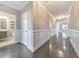 Bright hallway with dark hardwood floors and white wainscoting at 630 Eagles Lndg, Woodstock, GA 30188