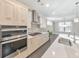 Modern kitchen with white cabinets, stainless steel appliances and quartz countertops at 630 Eagles Lndg, Woodstock, GA 30188