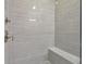 Large walk-in shower with gray tile and built-in seat at 630 Eagles Lndg, Woodstock, GA 30188