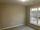 Well-lit bedroom with a large window and carpet flooring at 681 Courageous Ct, Lawrenceville, GA 30043