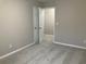 Spacious bedroom with door to bathroom and carpet flooring at 681 Courageous Ct, Lawrenceville, GA 30043