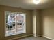 Bright bedroom with large window and carpet flooring at 681 Courageous Ct, Lawrenceville, GA 30043