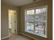 Bedroom with window, door to another room and carpet flooring at 681 Courageous Ct, Lawrenceville, GA 30043