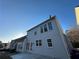 Rear view of two-story house, showcasing gray siding and patio at 681 Courageous Ct, Lawrenceville, GA 30043