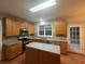 Kitchen features granite island and stainless steel appliances at 681 Courageous Ct, Lawrenceville, GA 30043