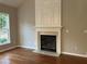 Living room with hardwood floors, fireplace, and built-in shelving at 681 Courageous Ct, Lawrenceville, GA 30043