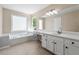 Bathroom with soaking tub, vanity, and separate shower at 2907 Wickford Nw Dr, Kennesaw, GA 30152
