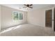 Spacious bedroom with carpeted floor, ceiling fan, and large window at 2907 Wickford Nw Dr, Kennesaw, GA 30152