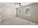 Bedroom with carpeted floor, ceiling fan, and two windows at 2907 Wickford Nw Dr, Kennesaw, GA 30152