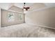 Main bedroom with tray ceiling, carpet, and ceiling fan at 2907 Wickford Nw Dr, Kennesaw, GA 30152