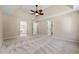 Main bedroom with high ceiling, carpet, and ensuite bathroom at 2907 Wickford Nw Dr, Kennesaw, GA 30152