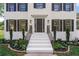 Front entrance with white stairs, black railings, and landscaping at 2907 Wickford Nw Dr, Kennesaw, GA 30152