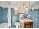 Clean bathroom with blue tile, updated vanity, and a shower/tub combination at 98 Ardmore Nw Pl # 3, Atlanta, GA 30309