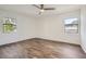 Spacious bedroom with wood-look flooring, ceiling fan, and large windows at 98 Ardmore Nw Pl # 3, Atlanta, GA 30309