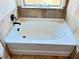 Bathroom with oval drop-in bathtub and tan tile at 15 Blanket Pass, Covington, GA 30016