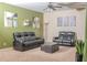 Gathering room with green walls, black reclining furniture and carpet at 15 Blanket Pass, Covington, GA 30016