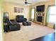 Gathering room with fireplace, black reclining furniture and carpet at 15 Blanket Pass, Covington, GA 30016