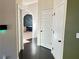 Hallway with dark hardwood floors and neutral colored walls at 15 Blanket Pass, Covington, GA 30016