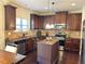 Kitchen with dark wood cabinets, granite counters and stainless steel appliances at 15 Blanket Pass, Covington, GA 30016