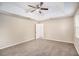 Spacious bedroom with carpet, ceiling fan and access to bathroom at 6602 Crossing Creek Pt, Austell, GA 30168