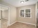 Simple dining area with hardwood floors and view into the living room at 6602 Crossing Creek Pt, Austell, GA 30168