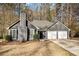 Gray house with white garage doors and landscaping at 6602 Crossing Creek Pt, Austell, GA 30168