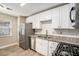 Modern kitchen with white cabinets and stainless steel appliances at 6602 Crossing Creek Pt, Austell, GA 30168