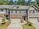 Brick townhouse exterior with two-car garage and manicured landscaping at 1983 Silver Birch Se Dr, Smyrna, GA 30080