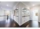 Upstairs hallway with hardwood floors and white railings at 611 Taymack W, Woodstock, GA 30188