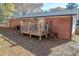 Exterior view showcasing a cozy backyard with a deck, lush greenery, and tree coverage at 2575 Baker Nw Rd, Atlanta, GA 30318