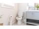 Powder room with gray vanity, ceramic tile flooring, and modern toilet at 2575 Baker Nw Rd, Atlanta, GA 30318