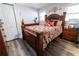 Bedroom with a wooden bed frame and dark red bedding at 2575 Baker Nw Rd, Atlanta, GA 30318