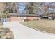 Charming brick home with a well-maintained front yard and a long concrete driveway at 2575 Baker Nw Rd, Atlanta, GA 30318