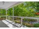 Front porch with white railings and lush greenery view at 311 Deering Nw Rd, Atlanta, GA 30309