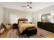 Well lit bedroom with queen bed, colorful rug and a ceiling fan at 10444 Park Walk Pt, Alpharetta, GA 30022