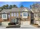 Brick front exterior of charming townhome with two-car garage at 10444 Park Walk Pt, Alpharetta, GA 30022