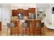 Kitchen boasts wood cabinets, granite island, and stainless steel appliances at 10444 Park Walk Pt, Alpharetta, GA 30022