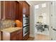 Kitchen boasts double ovens, granite countertops, and views to dining area at 10444 Park Walk Pt, Alpharetta, GA 30022