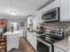 Modern kitchen with white cabinets and stainless steel appliances at 1202 Coan Dr, Locust Grove, GA 30248